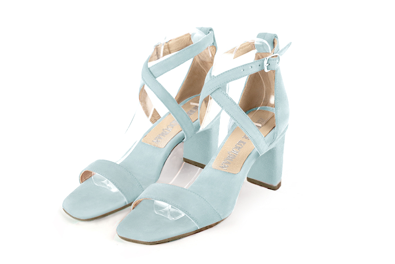  elegant sandals with crossed straps across the instep, closed at the back. . .